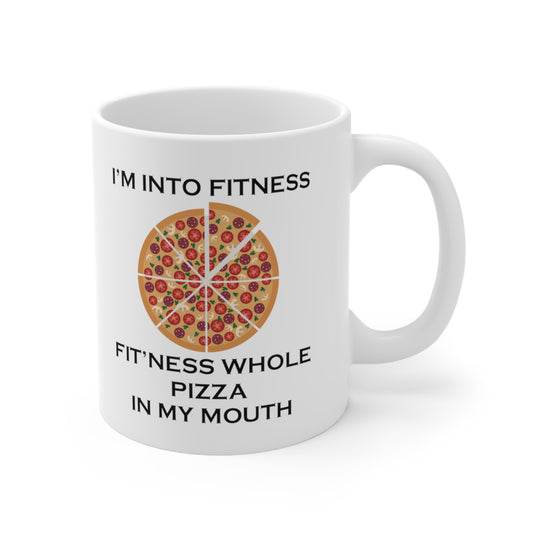 A white ceramic coffee mug with a design of a pizza and the funny quote: I'm Into Fitness, Fit'ness Whole Pizza In My Mouth