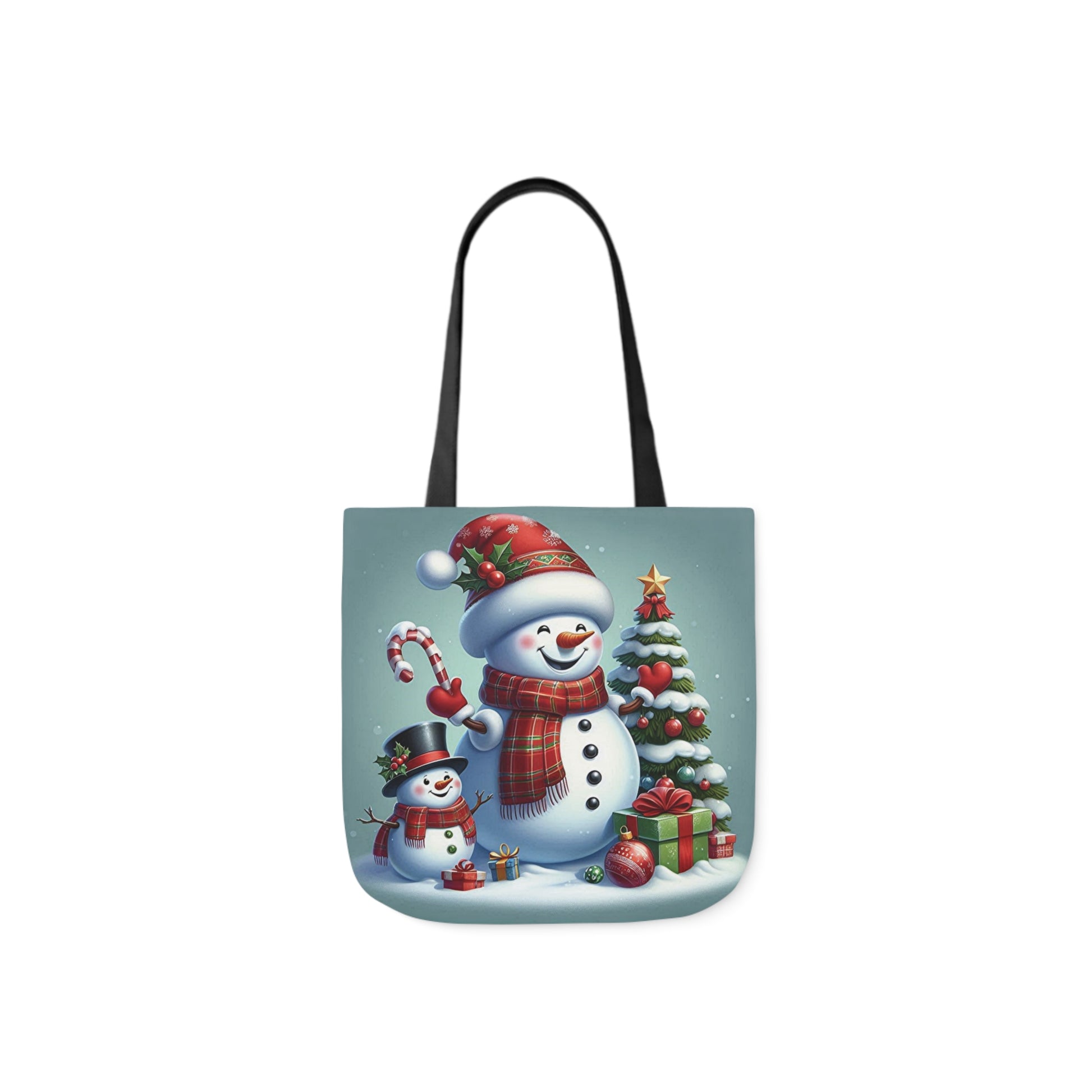 A canvas shoulder tote bag with a design of a jolly snowman next to a Christmas tree. 