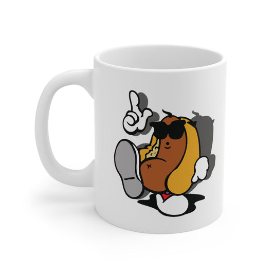 A white ceramic coffee mug with a design of a cartoon hot dog in sunglasses, looking like he is dancing.