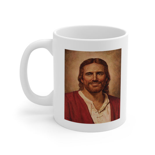 A white ceramic coffee mug with a painting of Jesus Christ 