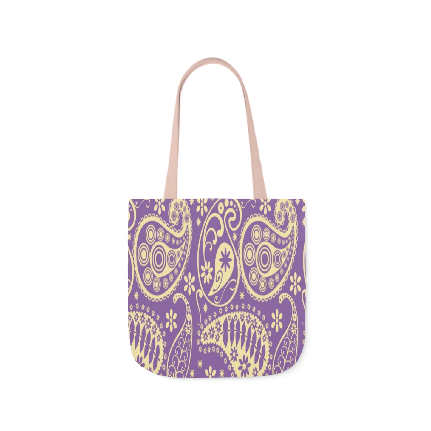 A canvas tote bag with a purple paisley pattern. The tote bag handles are light pink.