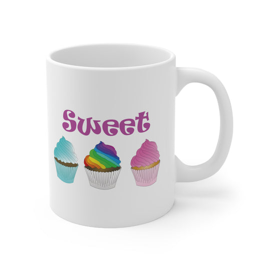 A white ceramic coffee mug with a design of 3 cupcakes with colourful frosting and the sword Sweet written in pink above them