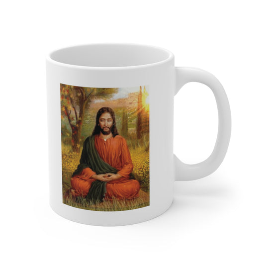 A white ceramic coffee mug with a painting of Jesus Christ meditating and praying in the woods
