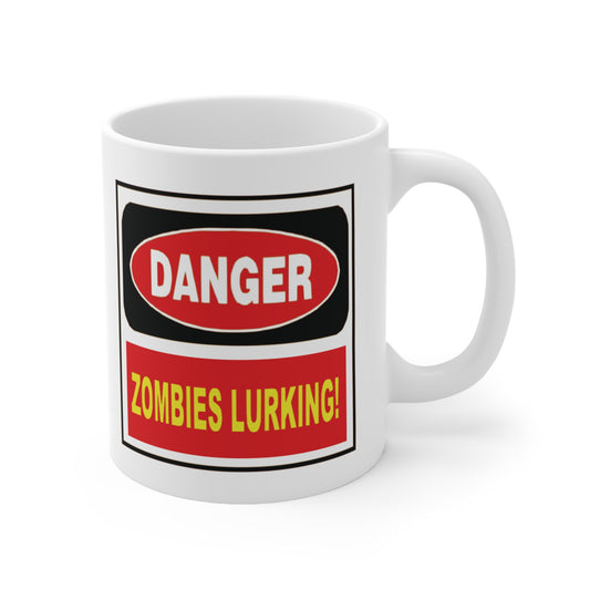 A white ceramic coffee mug with a design of a sign that reads: Danger Zombies Lurking!