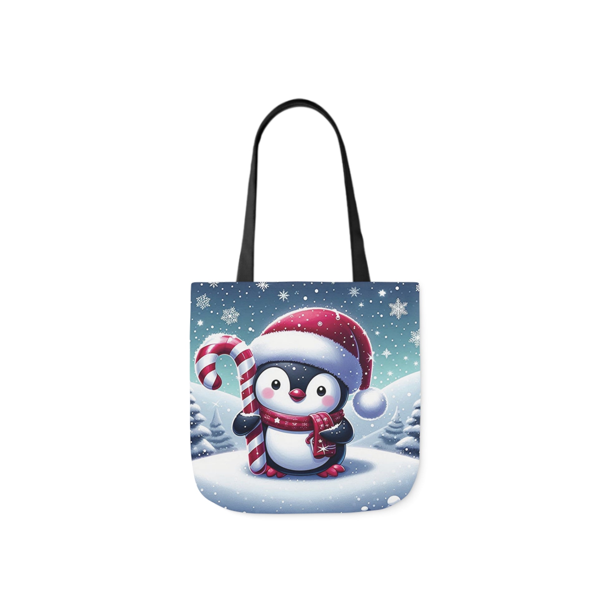 A canvas shoulder tote bag with a design of a penguin in a Santa hat and holding a big candy cane.