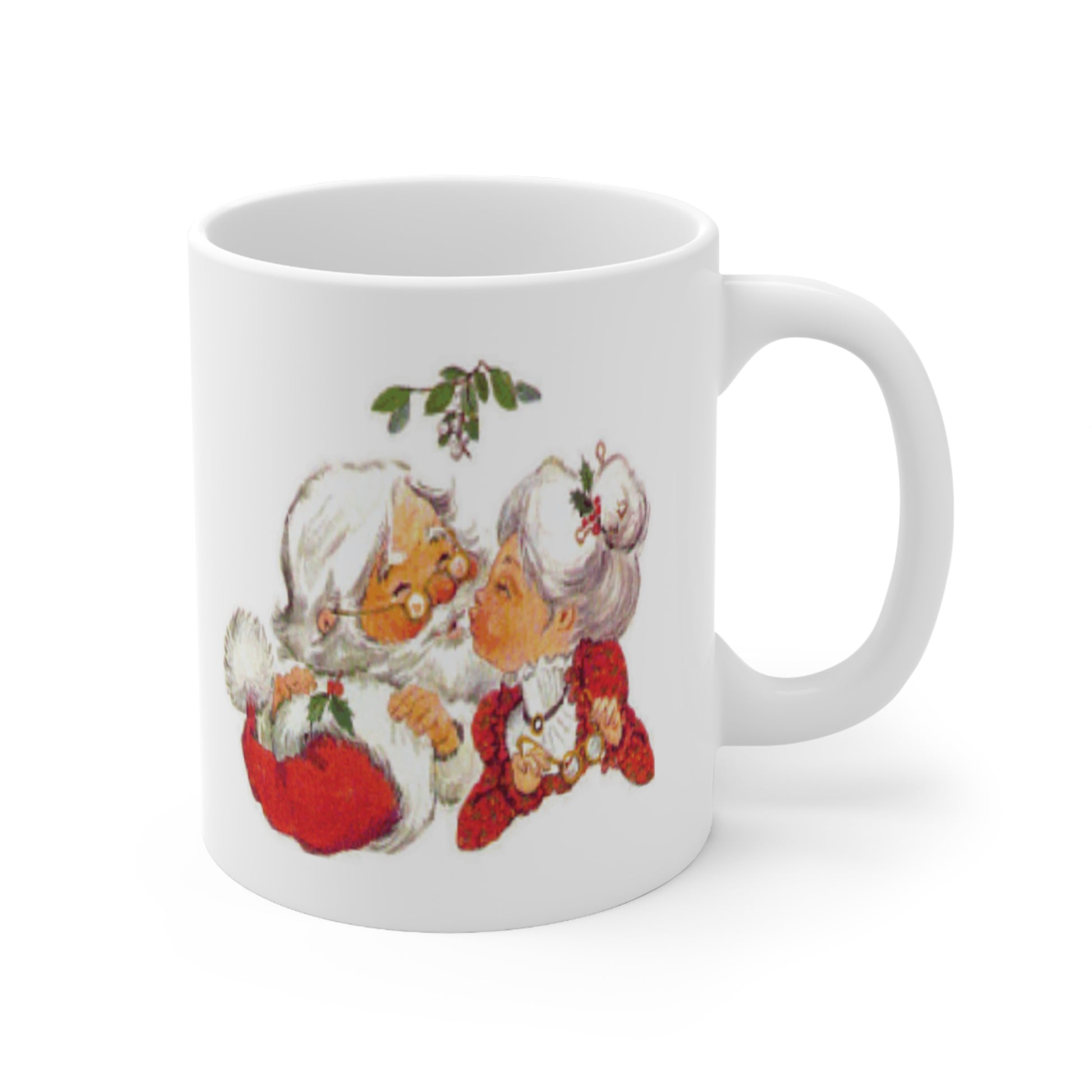 A white ceramic coffee mug with a vintage design of Santa Claus kissing Mrs Claus under the mistletoe