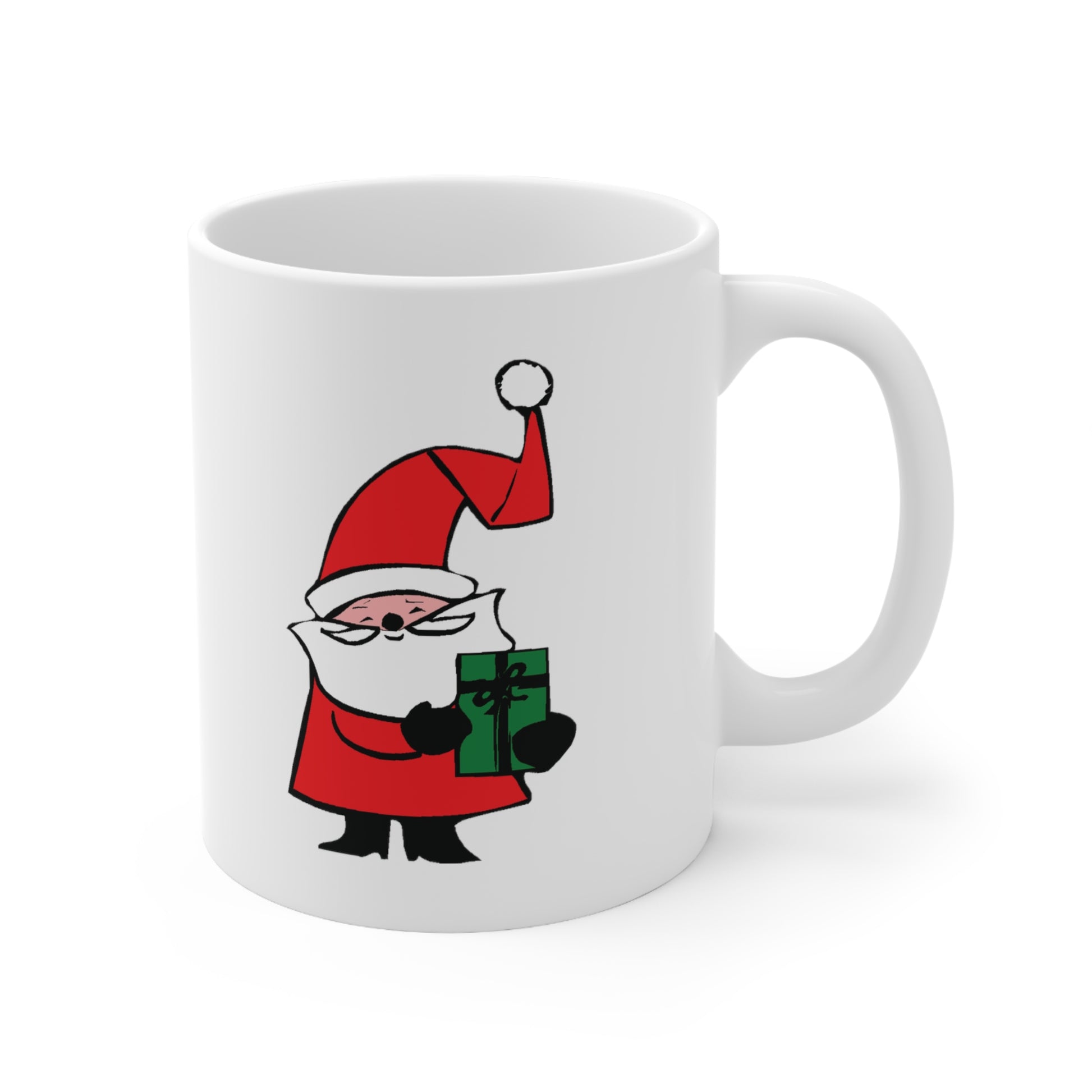 A white ceramic coffee mug with a design of a cute cartoon Santa Claus with a curly hat and holding a green present