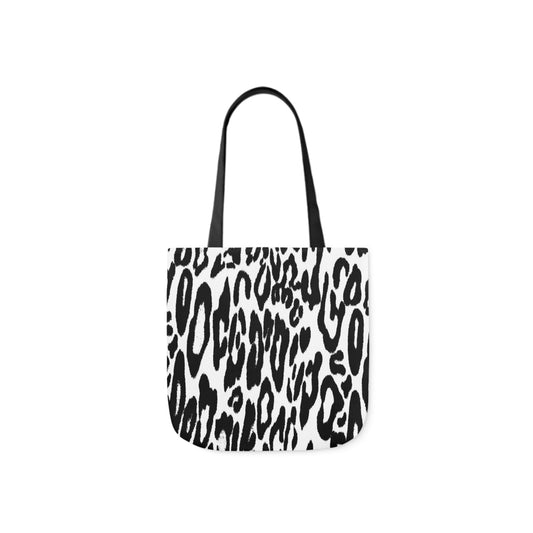 A canvas shoulder tote bag with a design of a black and white leopard skin pattern. The bag handles are black.