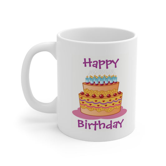 A white ceramic coffee mug with a design of a large birthday cake and the quote: Happy Birthday
