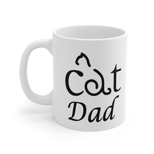 A white ceramic coffee mug with a design of a the words cat dad. The word cat has a cat shape made from the letter a.
