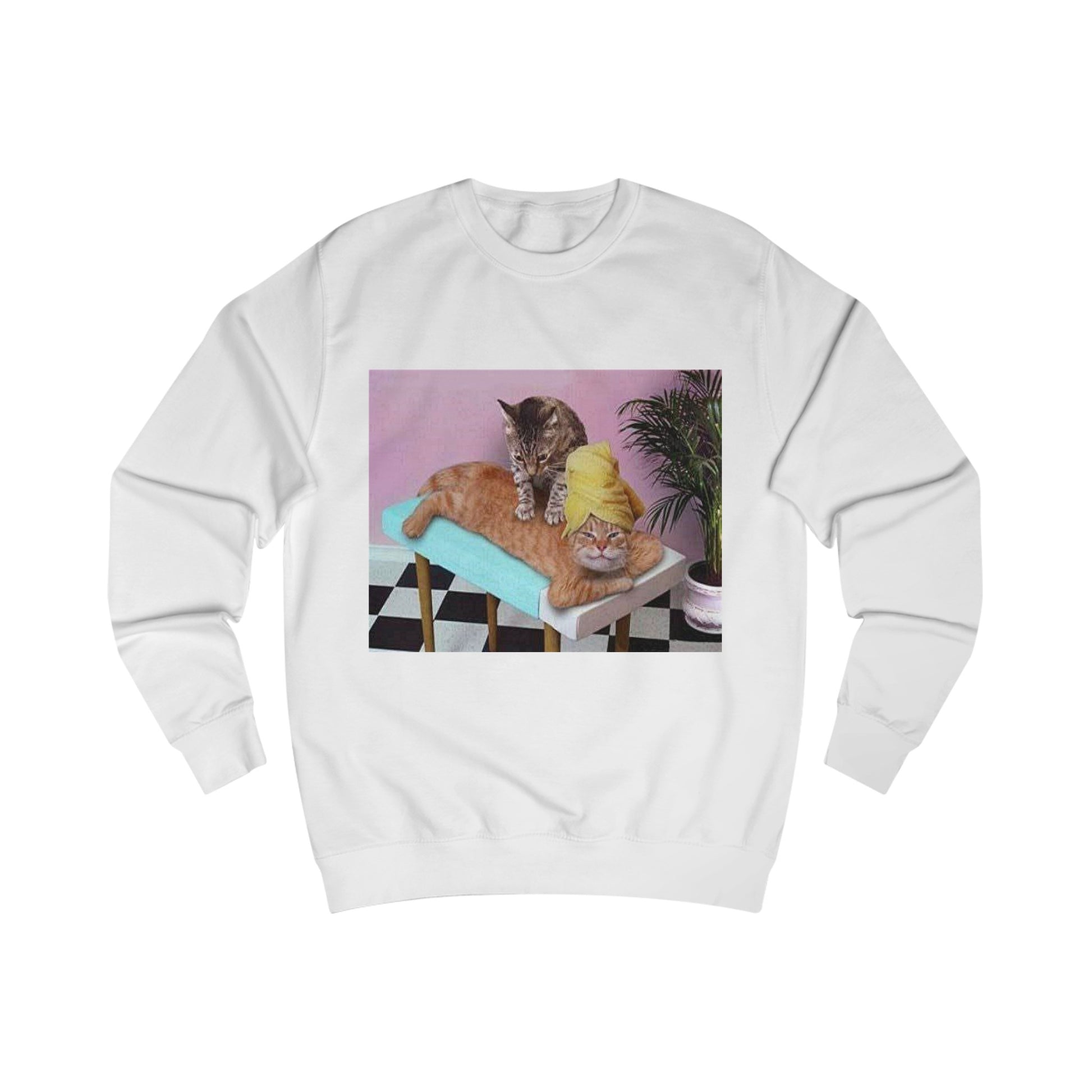 A white sweatshirt with a design of two cats in a spa. One cat is giving the other cat a massage.