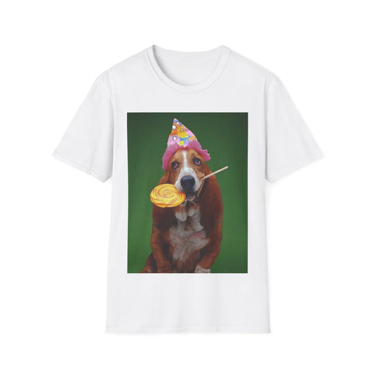 A white t-shirt with a photo of a basset hound dog wearing a birthday party hat and holding a lollipop in her mouth