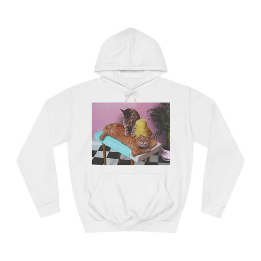 A white hoodie sweatshirt with a design of a funny photo of a cat giving another cat a massage.