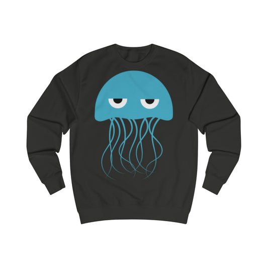 A black sweatshirt with a design of a cartoon blue jellyfish. His eye are half closed so he looks grumpy or sleepy