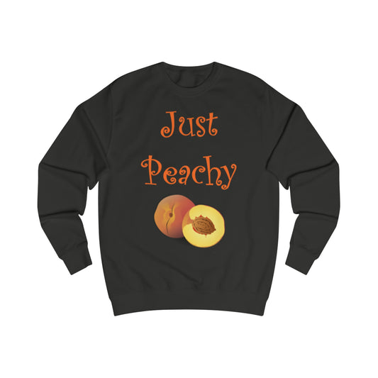  A black sweatshirt with a design of peaches, one peach is sliced open to reveal the inside. The words: Just Peachy are written in peach above the fruit